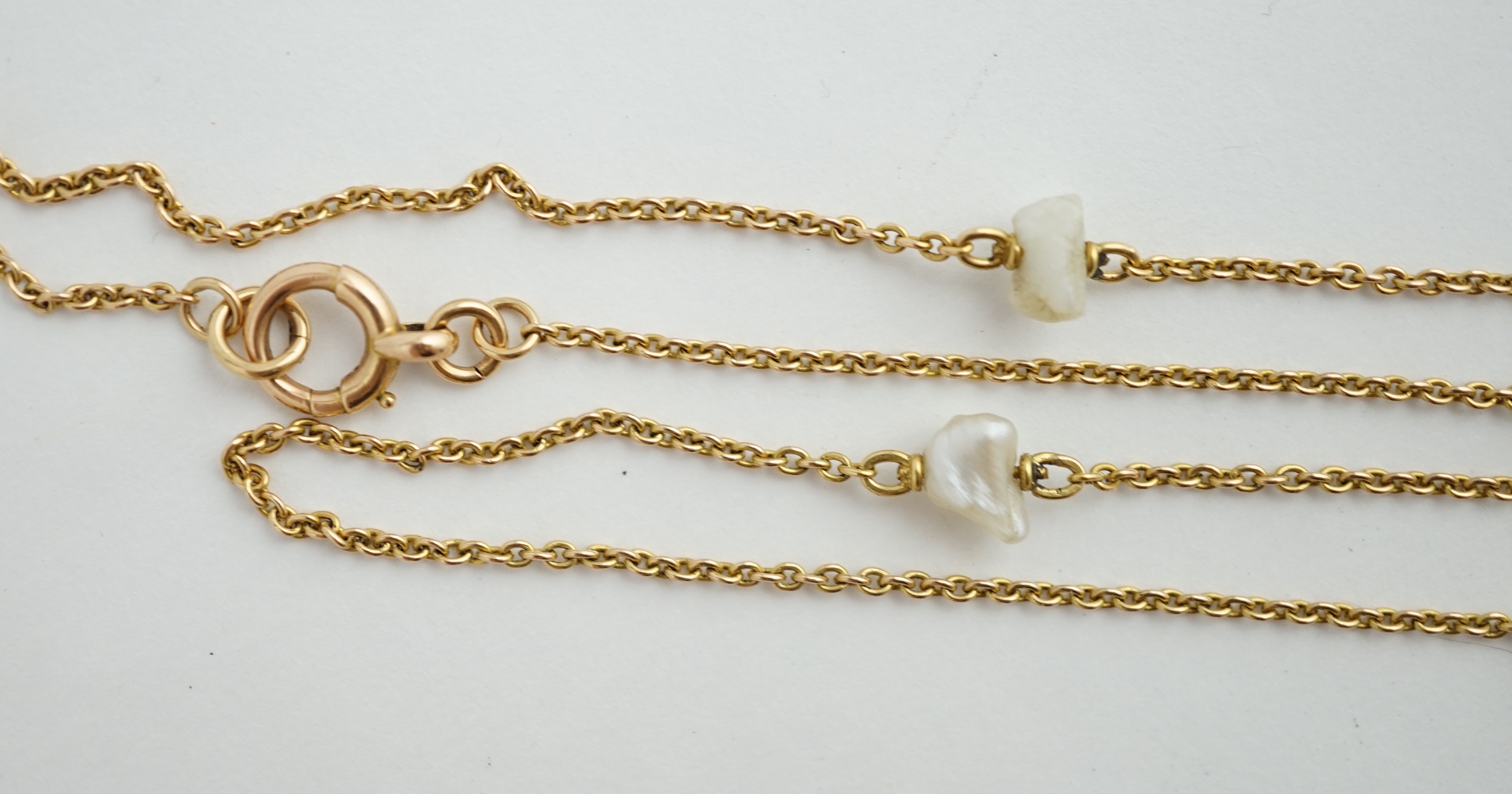 An early 20th century 15ct gold and ten stone baroque pearl set chain necklace